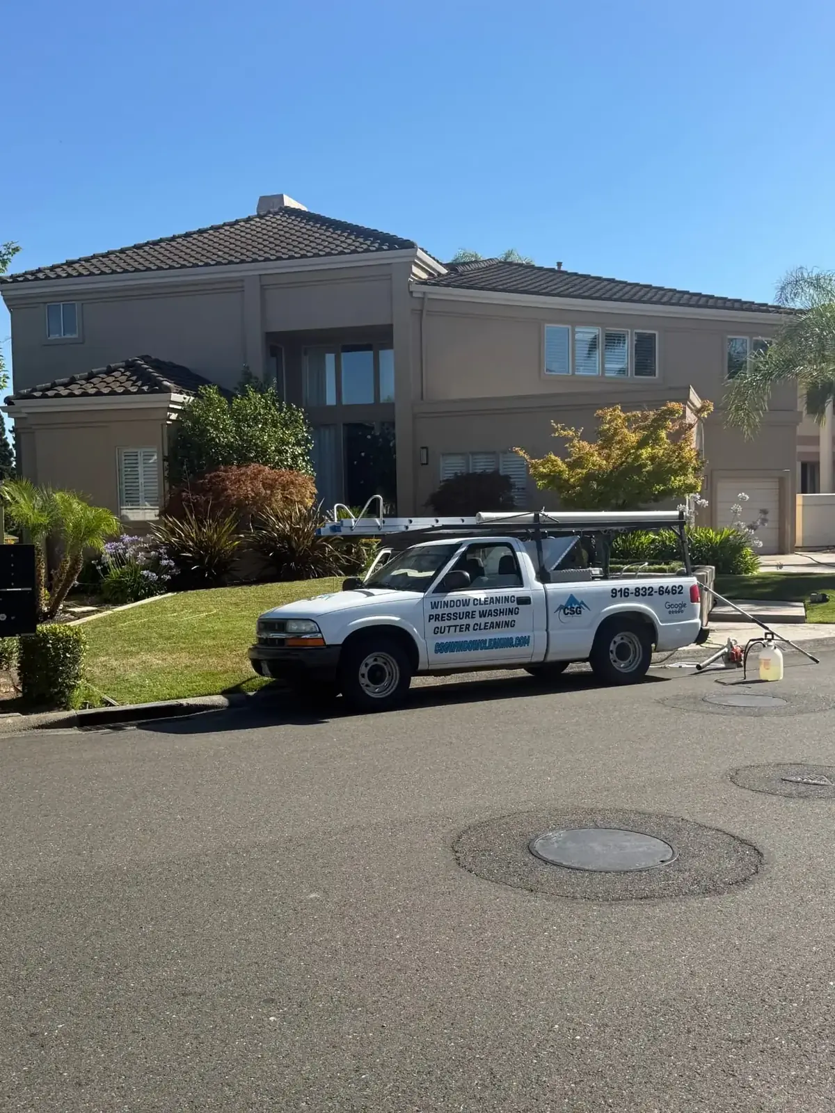 Home exterior soft washed by CSG, with clean stucco, trim and eaves